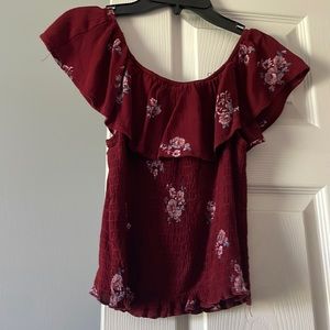 Maroon type off the shoulder shirt with flowers on it